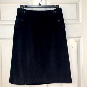 J Crew never worn black wool skirt fully lined. Flattering buttons at pockets.